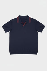 Navy knit polo shirt with red striped collar and short sleeves, perfect for casual weekends.